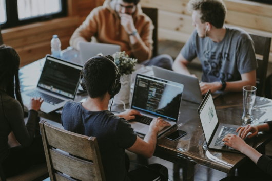 group of people using laptop computer